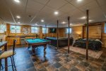 Basement family room with pool table and Murphy bed